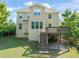 A large backyard with a view of the rear of the home, including deck and landscaping at 5011 Peachtree Town Ln, Knightdale, NC 27545