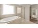 Bathroom featuring soaking tub and glass shower at 5011 Peachtree Town Ln, Knightdale, NC 27545