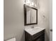 Bathroom featuring a dark wood vanity with white countertop and a framed mirror at 5011 Peachtree Town Ln, Knightdale, NC 27545