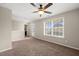 Bright bedroom with plush carpeting and a large window at 5011 Peachtree Town Ln, Knightdale, NC 27545