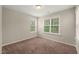 Inviting carpeted bedroom filled with bright, natural sunlight at 5011 Peachtree Town Ln, Knightdale, NC 27545