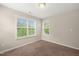 Cozy carpeted bedroom with natural light from two windows at 5011 Peachtree Town Ln, Knightdale, NC 27545