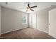 Inviting bedroom featuring carpet, window, and ceiling fan at 5011 Peachtree Town Ln, Knightdale, NC 27545