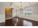 Dining room with wainscoting, hardwood floors and decorative chandelier at 5011 Peachtree Town Ln, Knightdale, NC 27545