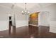 Dining room with wainscoting, hardwood floors and decorative chandelier at 5011 Peachtree Town Ln, Knightdale, NC 27545