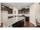 Spacious kitchen featuring granite countertops, dark wood cabinets, and stainless steel appliances at 5011 Peachtree Town Ln, Knightdale, NC 27545