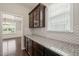 Stylish kitchen with granite countertops, mosaic backsplash, and dark wood cabinets at 5011 Peachtree Town Ln, Knightdale, NC 27545