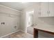Bright laundry room featuring tile floors, ample storage, and natural light at 5011 Peachtree Town Ln, Knightdale, NC 27545