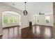 Open living room with abundant natural light and a view of a cozy fireplace at 5011 Peachtree Town Ln, Knightdale, NC 27545
