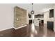 Open concept living space with hardwood floors and stylish wood accent wall at 5011 Peachtree Town Ln, Knightdale, NC 27545