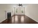 Inviting living room with fireplace, hardwood flooring, and bright windows at 5011 Peachtree Town Ln, Knightdale, NC 27545