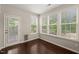 Sunroom with multiple windows, hardwood flooring, and access to outside deck at 5011 Peachtree Town Ln, Knightdale, NC 27545