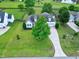 Aerial view of a charming two-story home with a well-manicured lawn and a long driveway at 5016 Swordfish Dr, Raleigh, NC 27603