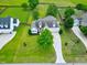 Aerial view of a well-maintained home with a manicured lawn and a long driveway at 5016 Swordfish Dr, Raleigh, NC 27603