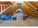 Unfinished attic space with exposed wooden beams and plywood flooring, offering ample storage or expansion possibilities at 5016 Swordfish Dr, Raleigh, NC 27603