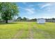 Spacious backyard with a large tree, storage shed, hammock, and well-maintained lawn at 5016 Swordfish Dr, Raleigh, NC 27603