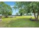 Large, well-maintained backyard with mature trees, fire pit, and seating area, perfect for outdoor entertaining at 5016 Swordfish Dr, Raleigh, NC 27603