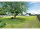 Expansive backyard featuring a mature tree, storage shed, fire pit, and ample lawn space at 5016 Swordfish Dr, Raleigh, NC 27603