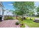 Backyard deck with a grill, flowerpots, and a view of the lawn, fire pit and comfortable backyard seating at 5016 Swordfish Dr, Raleigh, NC 27603