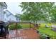 Backyard deck with a grill, seating, flowerpots and a view of the lawn and the landscaped backyard at 5016 Swordfish Dr, Raleigh, NC 27603