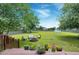 Large backyard with a firepit area, comfortable seating, and a view of the home and a white storage shed at 5016 Swordfish Dr, Raleigh, NC 27603