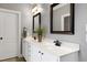 Bathroom featuring dual sinks, black fixtures, white cabinets and drawers, and tile flooring at 5016 Swordfish Dr, Raleigh, NC 27603