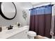 Bathroom featuring white vanity and sink, bronze fixtures, a decorative flower, and tile flooring at 5016 Swordfish Dr, Raleigh, NC 27603