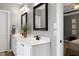 Bathroom featuring dual sinks, black fixtures, tile flooring, and doorway that leads to the bedroom at 5016 Swordfish Dr, Raleigh, NC 27603