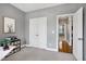 Bedroom with carpet, storage, and a view into another room with hardwood floors and natural light at 5016 Swordfish Dr, Raleigh, NC 27603