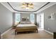 Spacious bedroom with tray ceilings, ceiling fan, carpeted floors, and plenty of natural light at 5016 Swordfish Dr, Raleigh, NC 27603