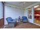 Comfortable covered porch with ceiling fan and wicker seating offering views of the garden at 5016 Swordfish Dr, Raleigh, NC 27603
