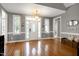 The front entrance features elegant hardwood floors and a striking white door at 5016 Swordfish Dr, Raleigh, NC 27603