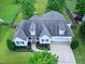 Aerial view of a two-story home with a gray roof, a manicured lawn, and a spacious driveway at 5016 Swordfish Dr, Raleigh, NC 27603