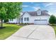 Beautiful home with a well-maintained driveway and a lush lawn, enhanced by mature trees at 5016 Swordfish Dr, Raleigh, NC 27603