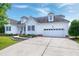 Attractive home featuring a two-car garage, manicured lawn, and well-maintained landscaping at 5016 Swordfish Dr, Raleigh, NC 27603