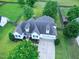 Aerial view of a two-story home with well-manicured lawn, mature trees, and a large driveway at 5016 Swordfish Dr, Raleigh, NC 27603