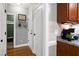 Hallway leading to the laundry room with wood flooring and modern decor at 5016 Swordfish Dr, Raleigh, NC 27603