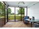 Inviting screened porch with wood floors, comfortable seating, and views of the lush backyard at 5016 Swordfish Dr, Raleigh, NC 27603
