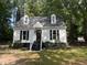 Beautiful home featuring a manicured lawn, dormer windows, and a classic chimney at 503 Pine Run, Knightdale, NC 27545