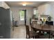 Bright kitchen with white cabinets, stainless steel appliances, and a round table eating area at 503 Pine Run, Knightdale, NC 27545