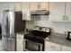 Modern kitchen features stainless steel appliances, granite countertops, and bright cabinetry at 503 Pine Run, Knightdale, NC 27545