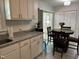 Eat-in kitchen with granite countertops, white cabinets, and a cozy dining area with a round table at 503 Pine Run, Knightdale, NC 27545