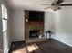 Inviting living room features a brick fireplace, ceiling fan, and hardwood floors at 503 Pine Run, Knightdale, NC 27545
