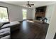 Spacious living area with a brick fireplace, ample natural light, and hardwood floors at 503 Pine Run, Knightdale, NC 27545