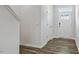 Bright entryway features a wood floor, white walls, and a front door with decorative window panels at 510 Resteasy Dr, Apex, NC 27539