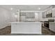 Bright kitchen showcases gray cabinetry, stainless appliances, a white tile backsplash, and a center island at 510 Resteasy Dr, Apex, NC 27539