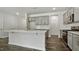 Bright kitchen features an island, gray cabinets, recessed lights, and stainless steel appliances at 510 Resteasy Dr, Apex, NC 27539