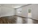 Bright living area features a large window, a glass panel door, and modern flooring at 510 Resteasy Dr, Apex, NC 27539