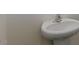 Bathroom with a white, pedestal sink and sleek, modern faucet at 510 Resteasy Dr, Apex, NC 27539