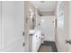 Bathroom featuring white cabinets, gray countertop, a tiled shower, and a window at 5121 Raintree Rd, Durham, NC 27712